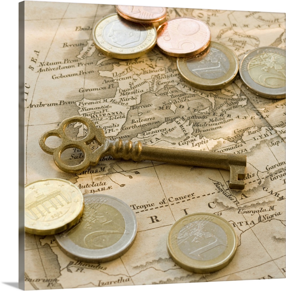 Close up of euro coins, map and antique key