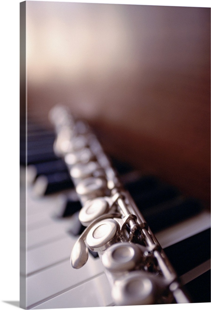 Close-up of flute on piano keys