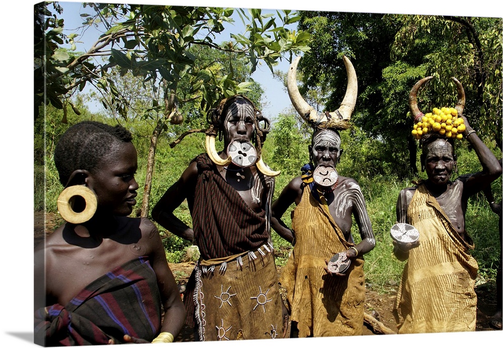 Close up of four traditionally costumed Mursi women. Jinka, Ethiopia, Africa, February 21, 2020.