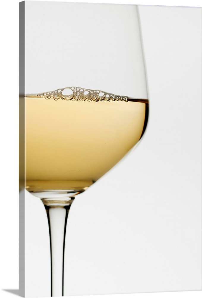 Close up of glass of white wine on white background