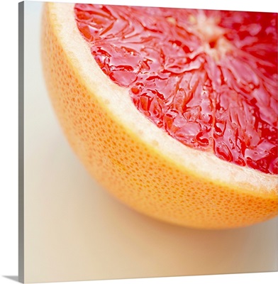 Close up of halved pink grapefruit.