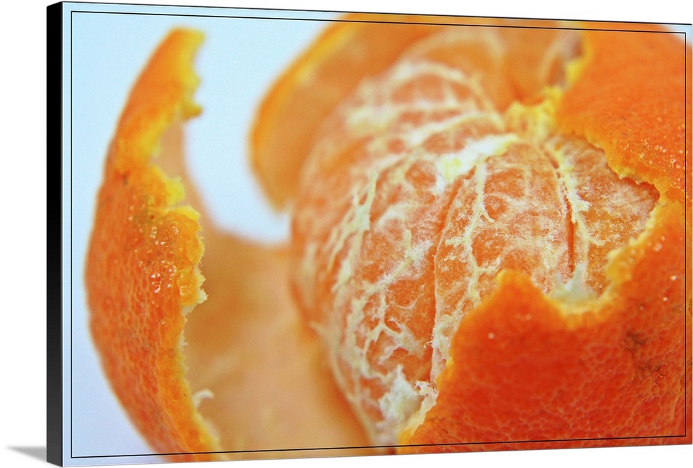 Close up of partly peeled juicy orange.