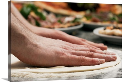 Close-up of pizza baker making dough