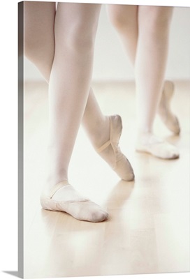 close up of two ballet dancers feet