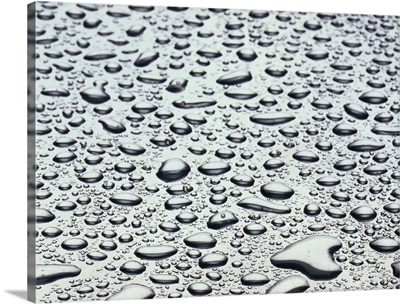 Close-up of water droplets on a gray surface