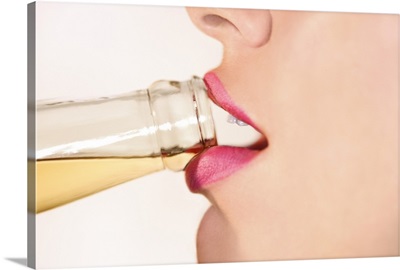 Close-up profile view of a woman's lips drinking from a bottled beer
