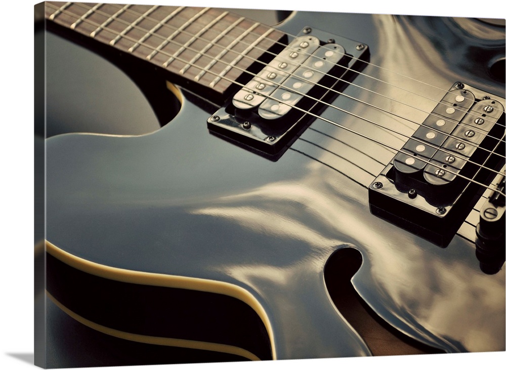 Close up shot of black guitar.