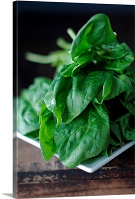 Closeup of spinach on rustic table.