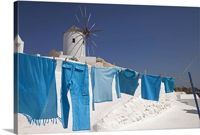 Clothes hanging to dry near a windmill in Oia, Santorini, Greece
