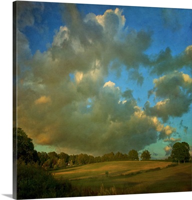 Cloudscape over hillside fields