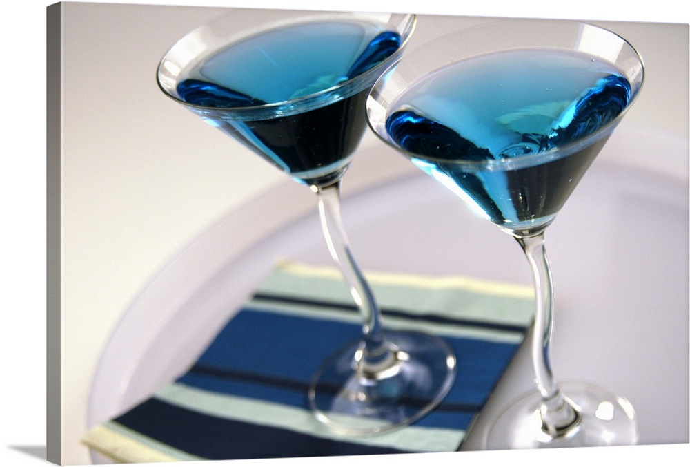Cocktail glasses containing blue drink, close up