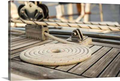 Coiled line, rope, on teak deck of 62 ft sailboat