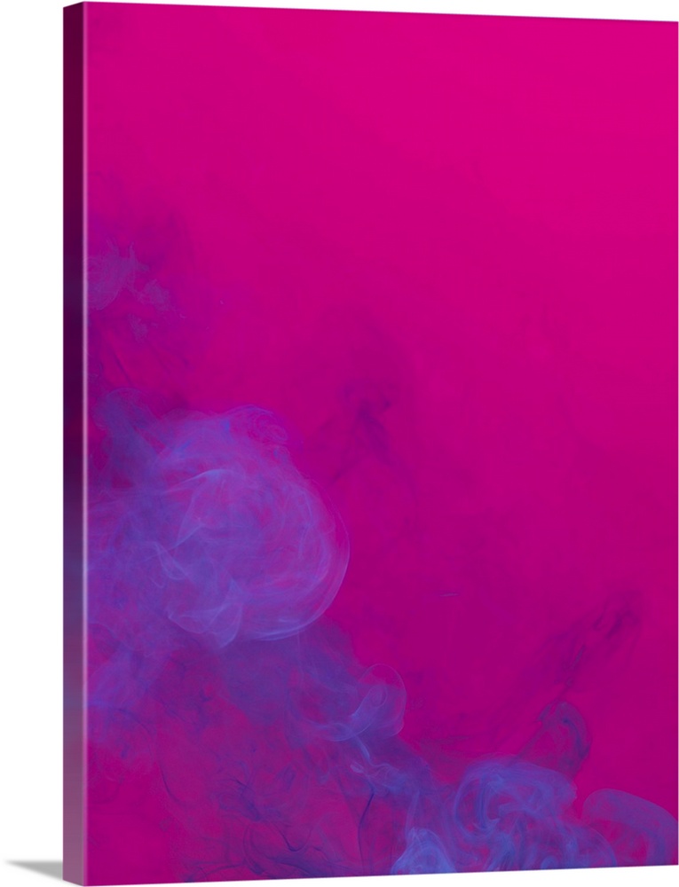 Blue smoke that rises up and mixed into beautiful abstractions on a pink background
