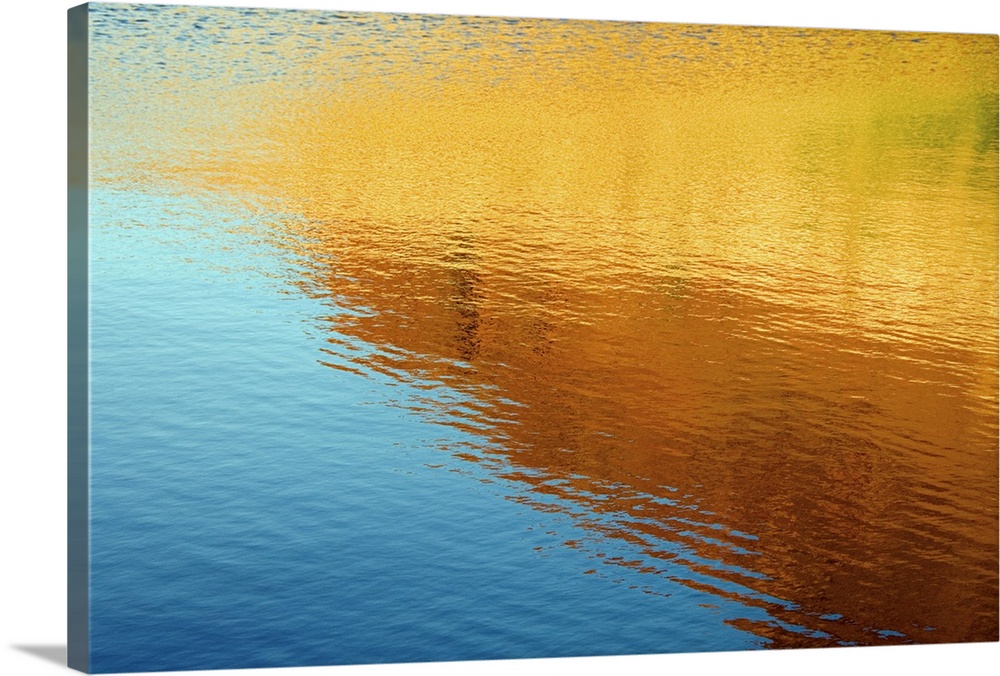 Colorful photograph of ripples in water.