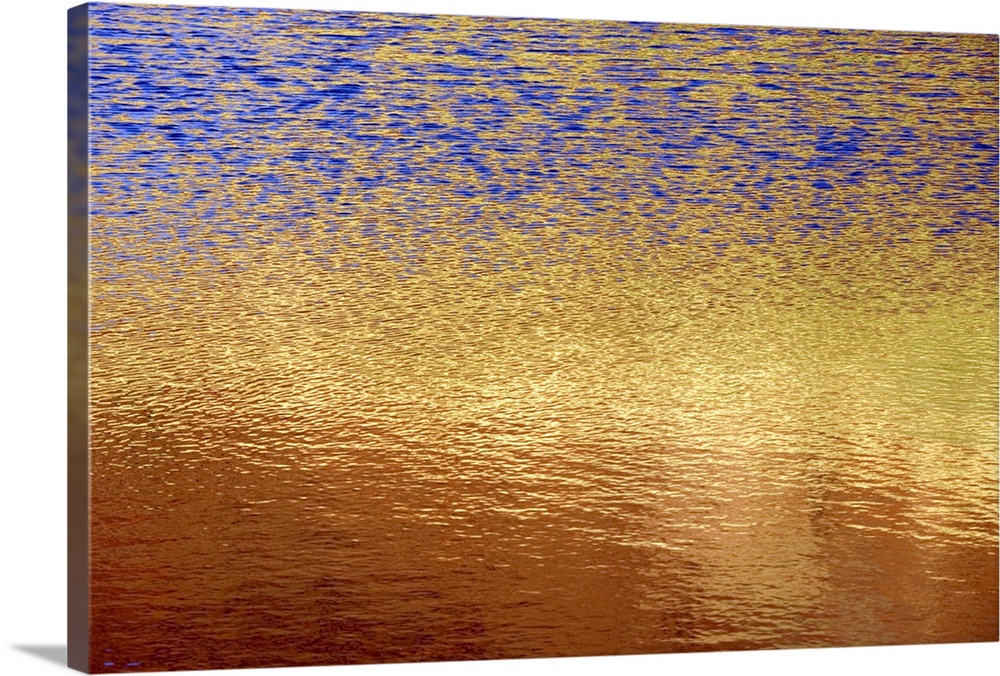 The photograph of a setting sunos light shimmering on a lake takes on an abstract artwork look in this decorative wall art...