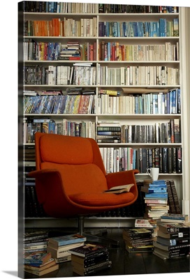 comfortable chair surrounded by books