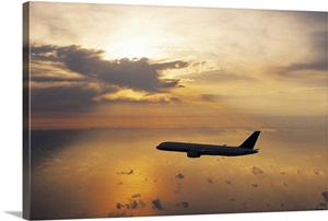Commercial Aeroplane Flying Above the Sea at Dusk image thumbnail