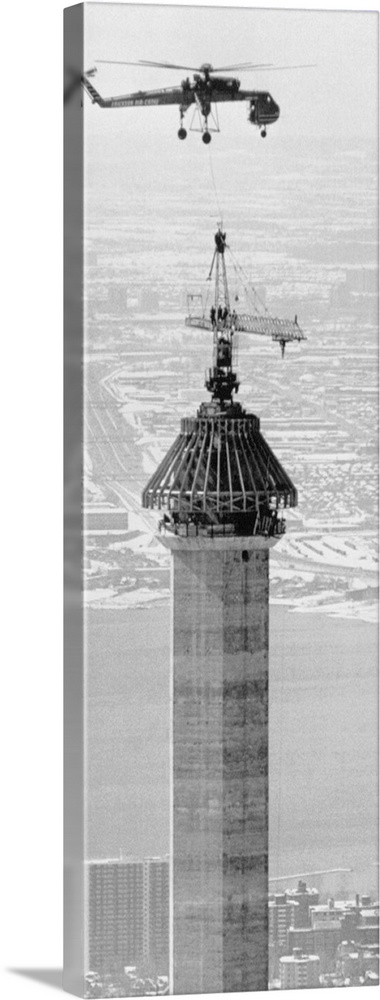 Multiple images of a Sikorsky CH-54 hauling pieces of a crane during the construction of the Canadian National Tower in To...