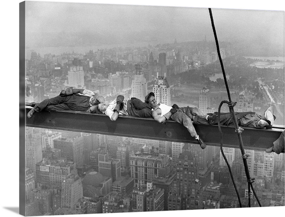Four construction workers take a nap, balanced on a steel girder hung 800 feet over Manhattan, during the construction of ...
