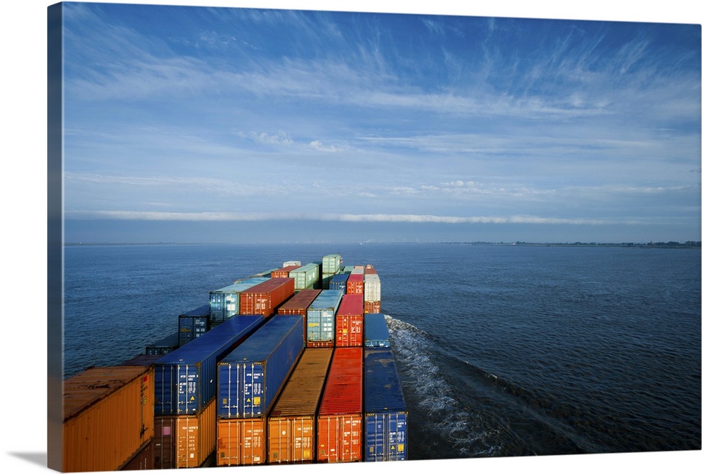 Container ship on Elbe river heading towards North Sea (sunrise)