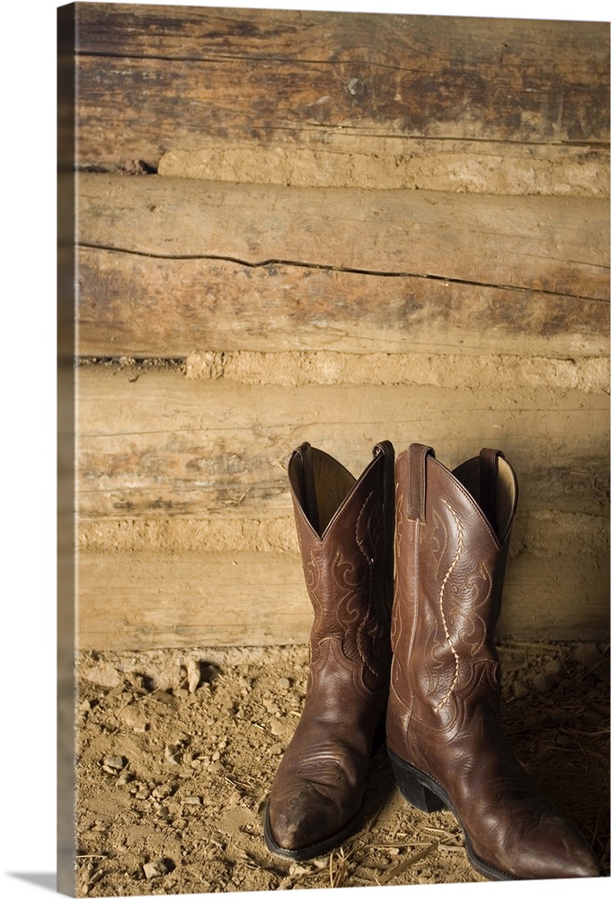 Cowboy boots near door to barn