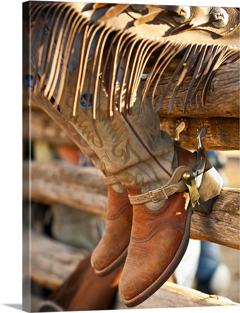 Cowboy boots on fence