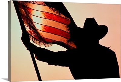 Cowboy Holding Stars And Stripes, Silhouette, Texas, USA