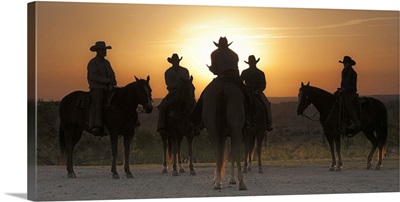 Cowboys and cowgirl at sunrise