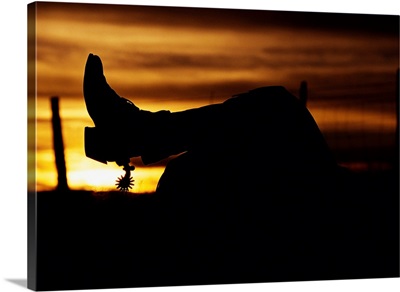Cowboy's Boot And Spur Silhouetted At Sunrise