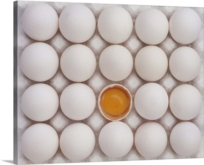 Cracked egg surrounded by whole eggs