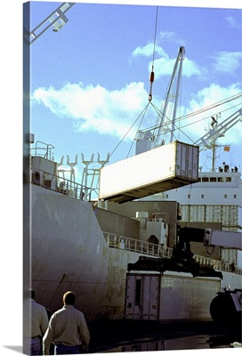 Cranes carrying cargo containers at a port