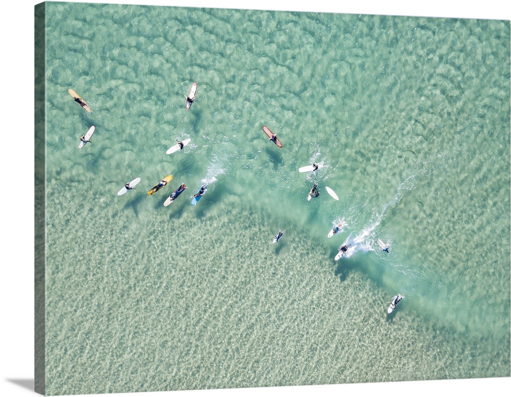Crystal clear waters with surfers seen from above. Coastline of Australia.