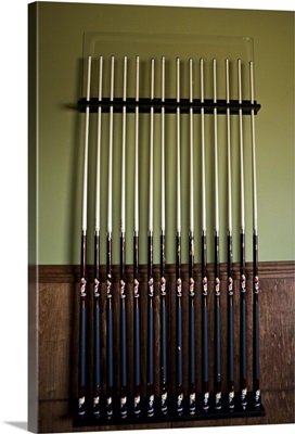 Cue sticks lined up against wall