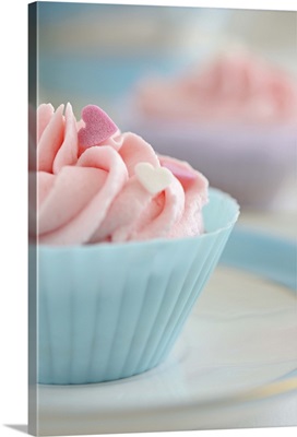 Cupcakes with pink frosting and hearts of sugar.
