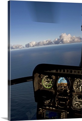 Dashboard of a helicopter flying over an ocean