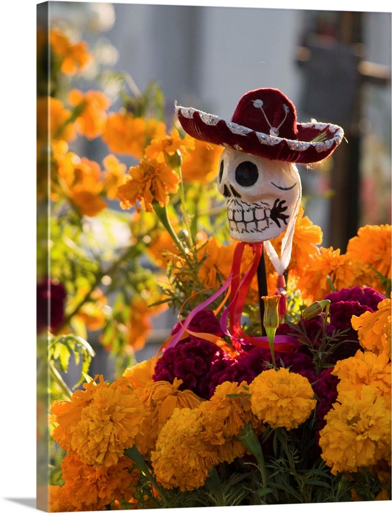 Marigolds and a skull with a sombrero decorate a grave during the Day of the Dead celebration in San Miguel de Allende, Me...