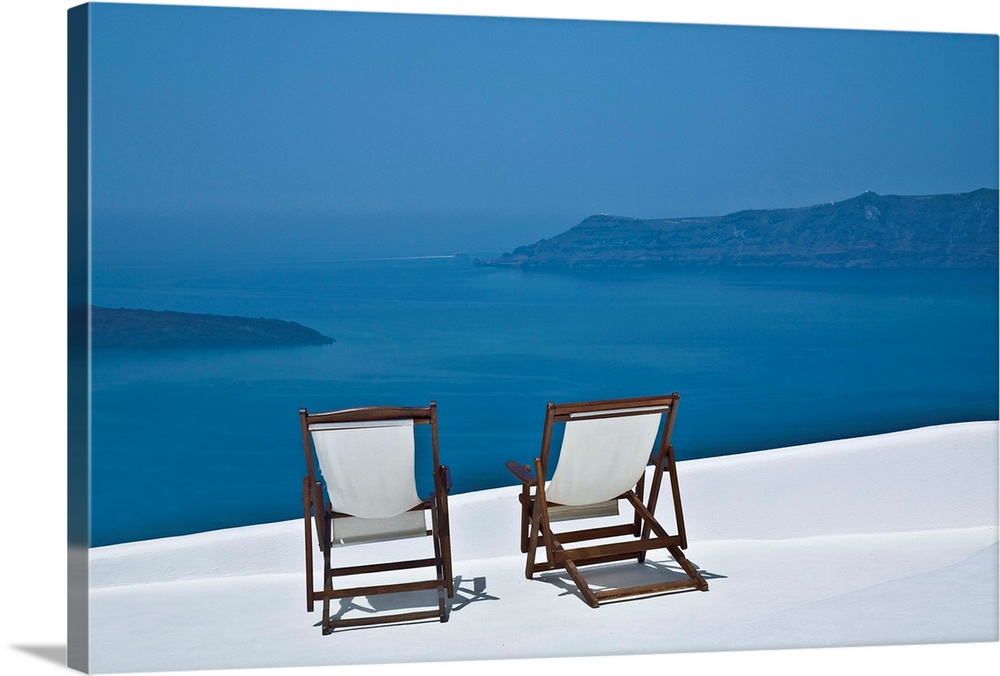 Two empty deck chair on balcony,Santorini,Greece.