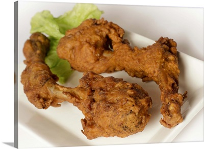 Deep fried chicken legs with lettuce