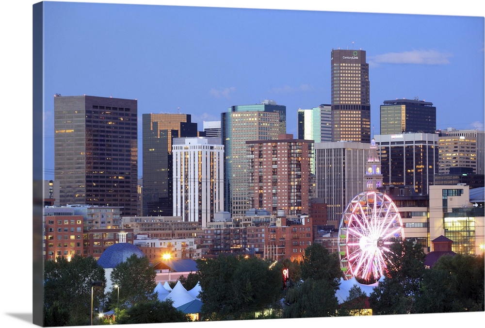 Denver, Colorado skyline at dusk with theme park ride in foreground