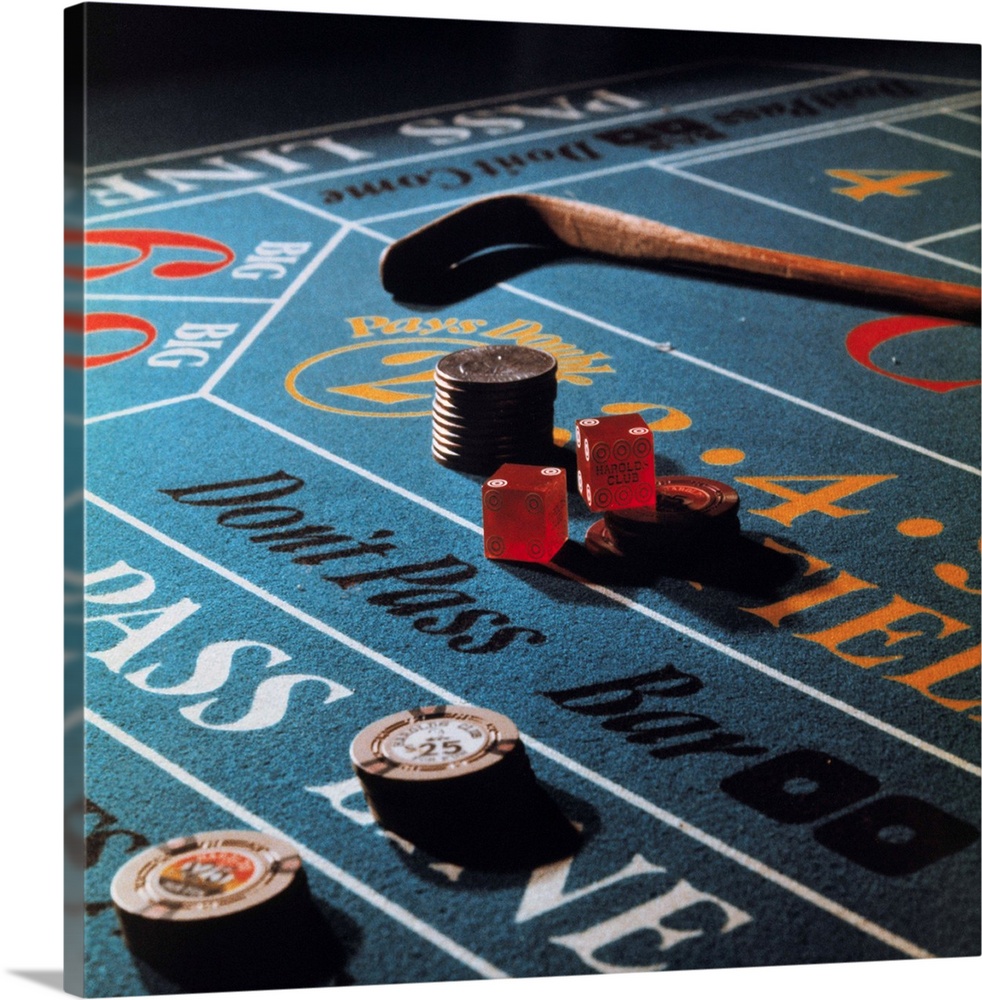 Close up view of dice and chips on craps table.