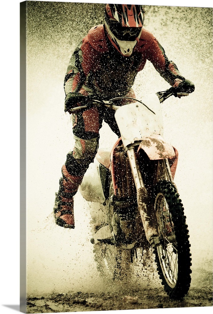 Dirt bike rider splashes through water filled stream Wall Art, Canvas