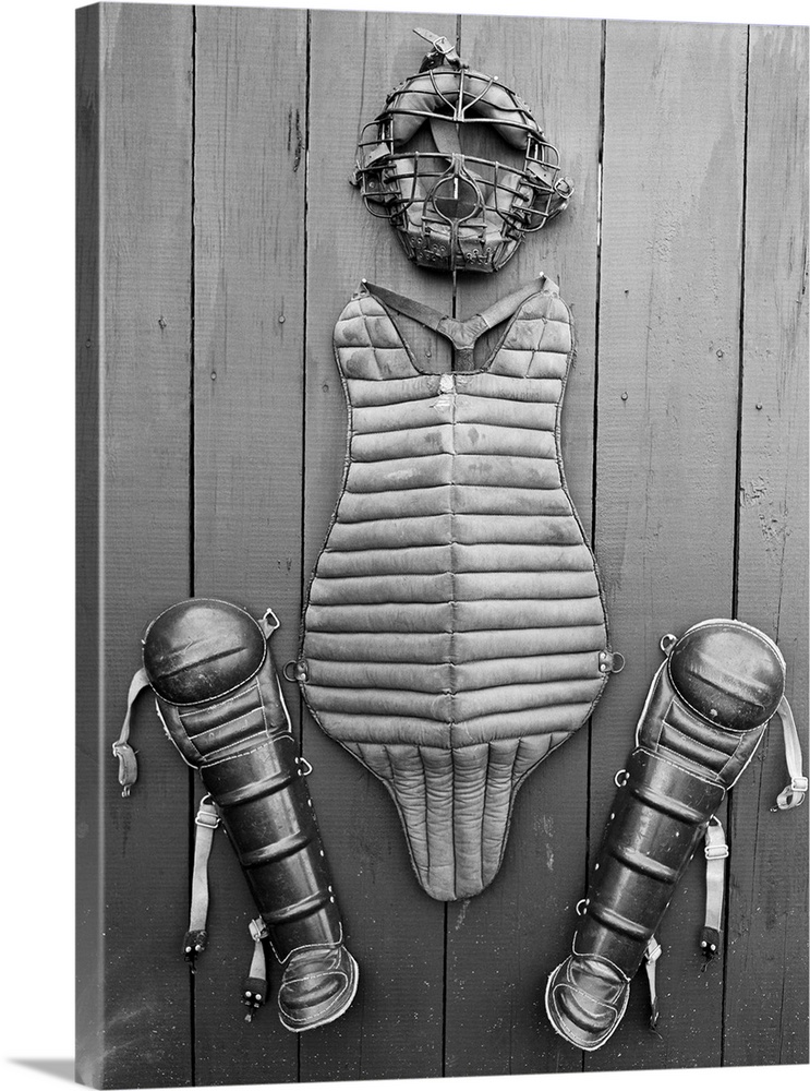 Here is the harness worn by a big league catcher. It consists of face mask, a padded affair of steel bars, leather and stu...