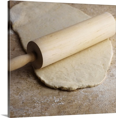 Dough and rolling pin on countertop
