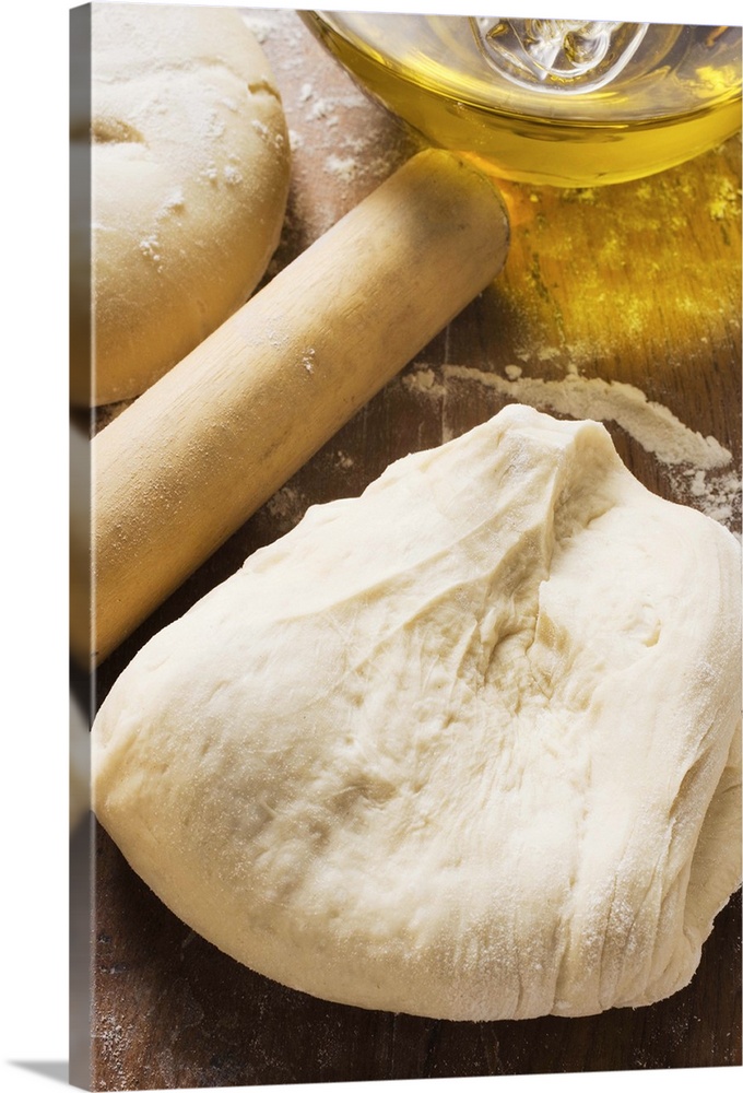 Dough, rolling pin, ball of dough and olive oil