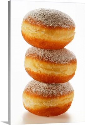 Doughnuts with icing sugar, in a pile