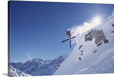 Downhill skier in midair, low angle view