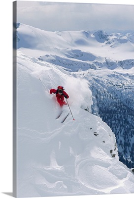 Downhill skier turning on slope