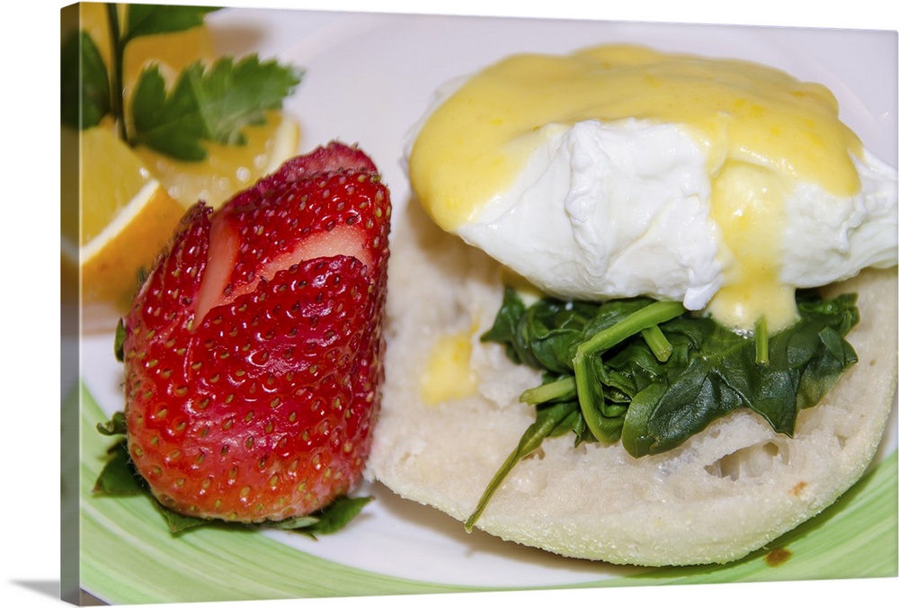 Eggs Benedict Florentine; featuring fresh spinach instead of ham, and served with a strawberry and orange slice.