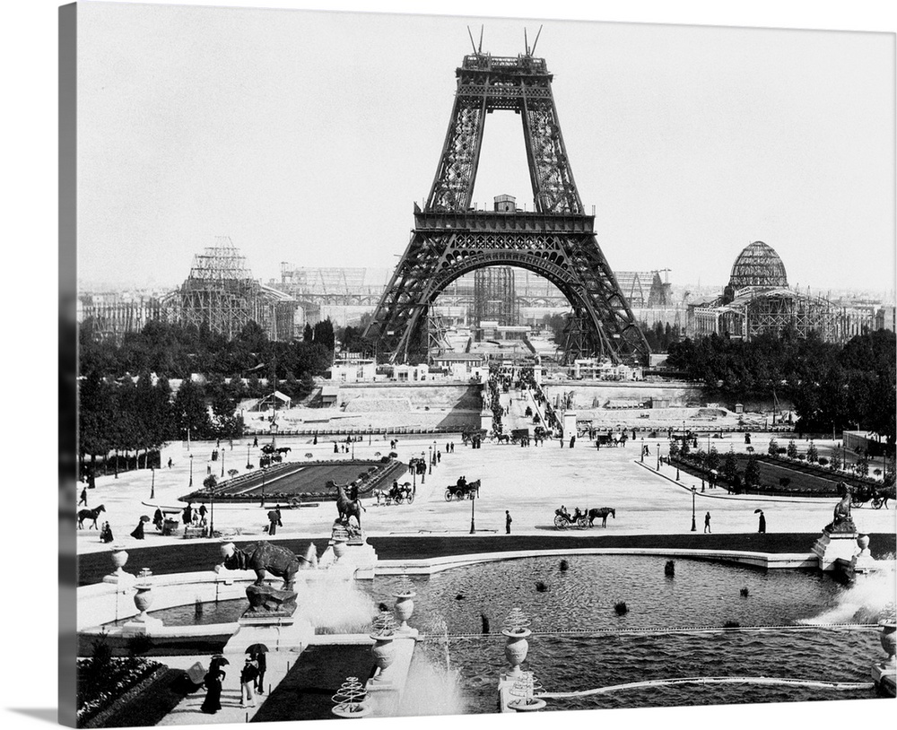 The Eiffel Tower being constructed halfway up with surrounding exhibition area. Undated photograph.