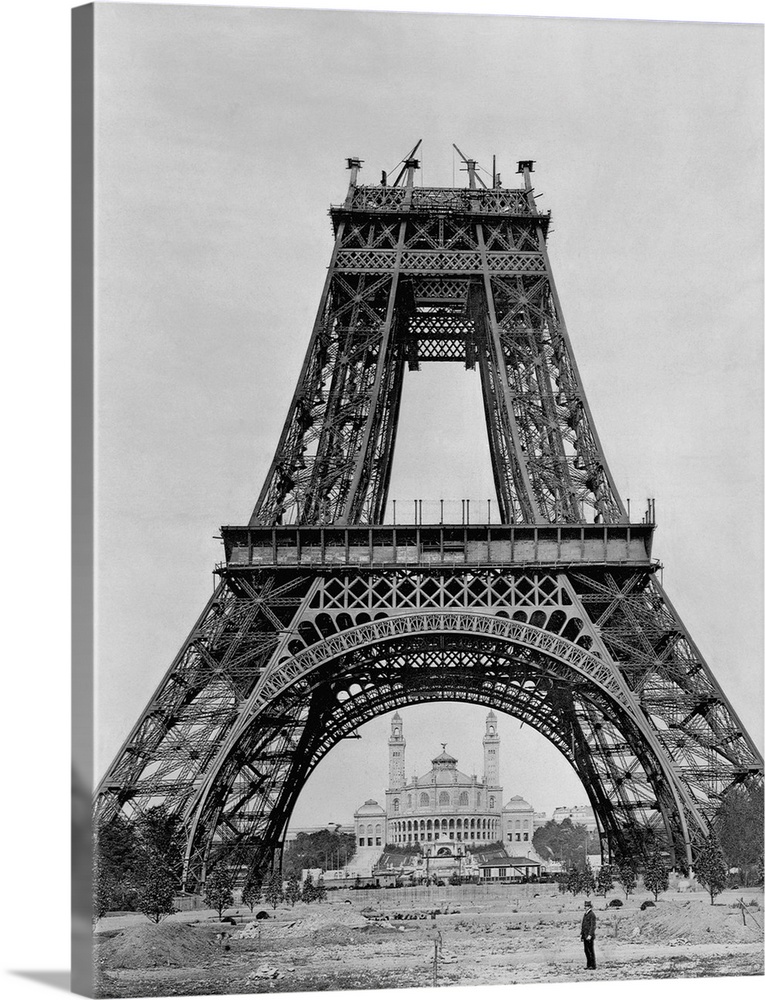 Under construction for the Paris Exposition of 1889, the partially built Eiffel Tower awaits its crowning tower shaft.